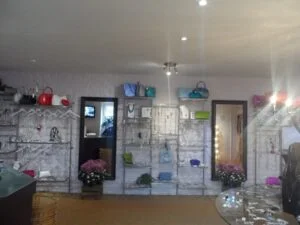Colourful handbags of display at Lapstone - using Dymond Engineering metal wall displays